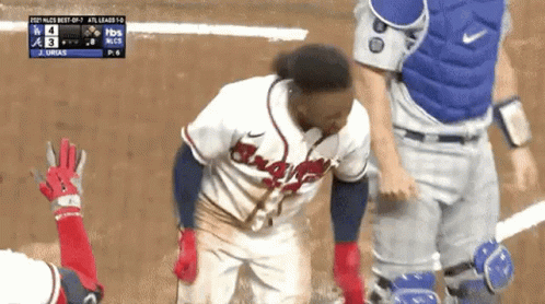 A Baseball Player Wearing A Braves Jersey Is Standing On A Baseball Field GIF