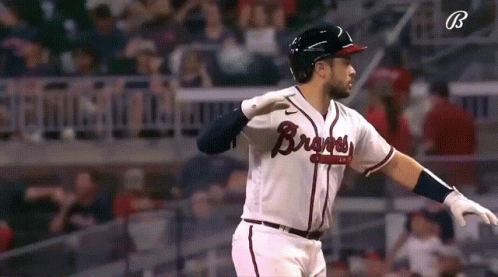 A Baseball Player Wearing A Braves Jersey Is Standing On The Field GIF