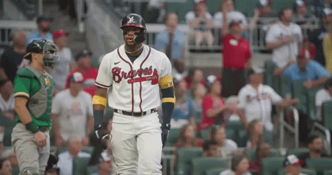 A Baseball Player Wearing A Braves Jersey Stands In Front Of A Crowd GIF