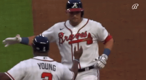 A Baseball Player Wearing A Braves Jersey Talks To Another Player GIF