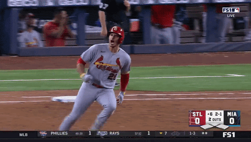 A Baseball Player Wearing A Cardinals Jersey Runs Towards Home Plate GIF