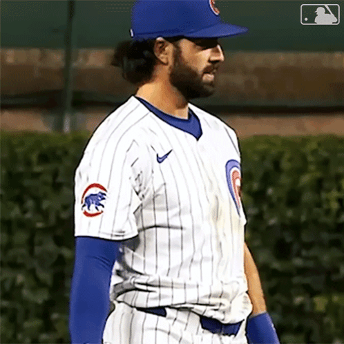 A Baseball Player Wearing A Chicago Cubs Uniform Is Standing On The Field GIF