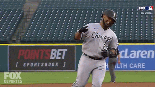 A Baseball Player Wearing A Chicago Uniform Is Running On The Field GIF
