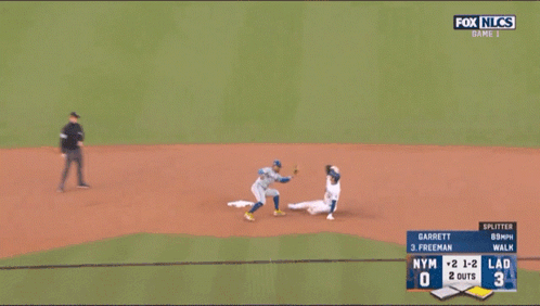 A Baseball Player Wearing A Dodgers Jersey Is Laying On The Ground GIF