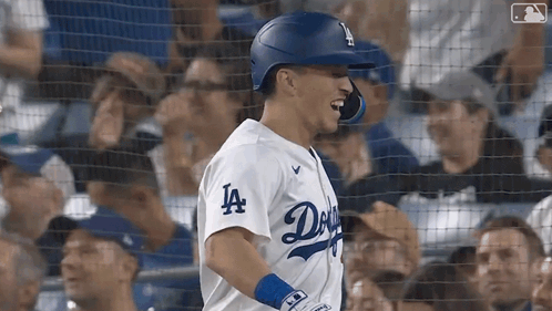 A Baseball Player Wearing A Dodgers Jersey Is Standing In Front Of A Crowd GIF