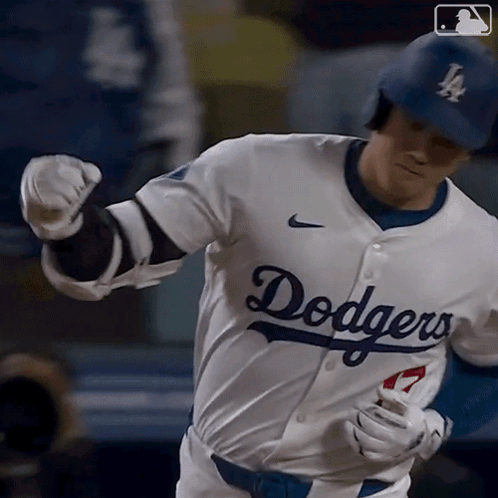 A Baseball Player Wearing A Dodgers Jersey Runs Towards Home Plate GIF