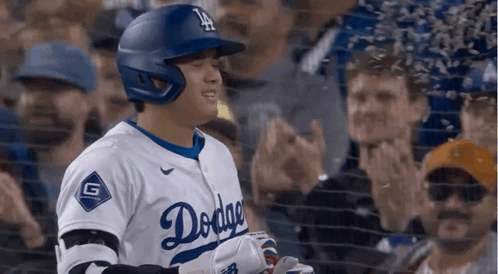 A Baseball Player Wearing A Dodgers Uniform Is Standing In Front Of A Crowd GIF