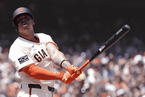 A Baseball Player Wearing A Giants Jersey Swings His Bat GIF