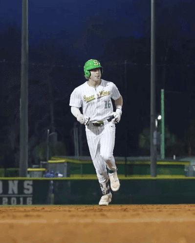 A Baseball Player Wearing A Green Helmet And A White Jersey That Says ' Greenies ' On It GIF