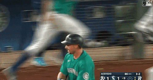 A Baseball Player Wearing A Green Seahawks Jersey GIF