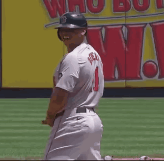 A Baseball Player Wearing A Helmet And A Jersey With The Number 1 On It Is Smiling . GIF