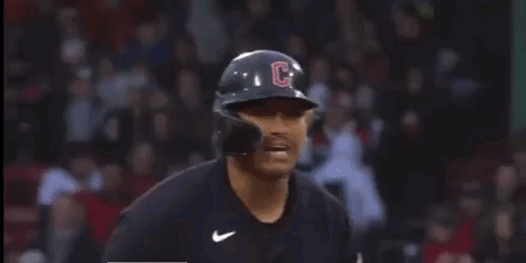 A Baseball Player Wearing A Helmet And Gloves With The Letter C On It . GIF