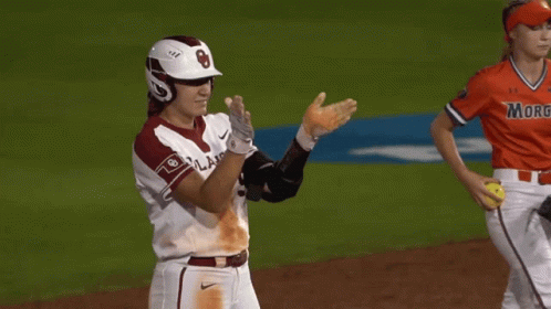 a baseball player wearing a helmet and knee pads with the letter b on it