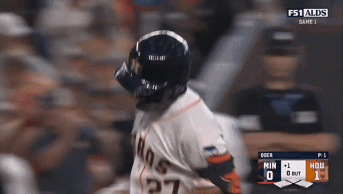 A Baseball Player Wearing A Helmet And Number 27 On His Jersey GIF