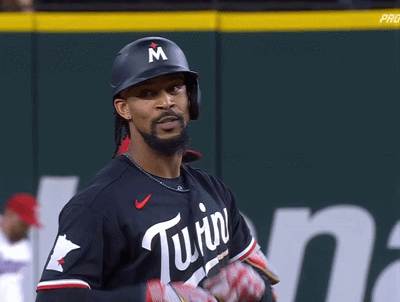 A Baseball Player Wearing A Helmet With A Letter M On It GIF