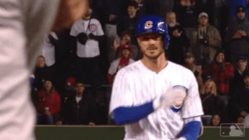 A Baseball Player Wearing A Helmet With The Letter C On It Stands In Front Of A Crowd . GIF