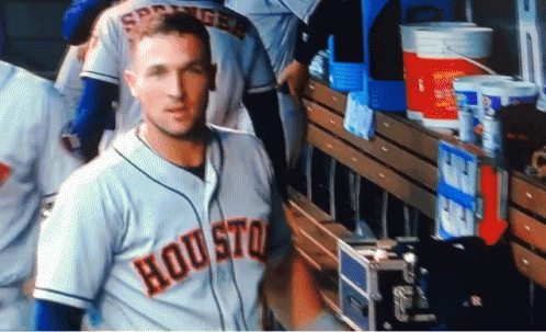 A Baseball Player Wearing A Houston Jersey Stands In The Dugout GIF