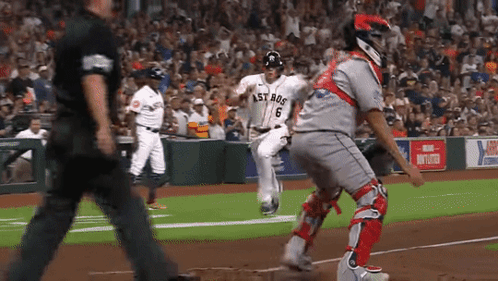 A Baseball Player Wearing A Jersey That Says Astros Is Running Towards The Base GIF
