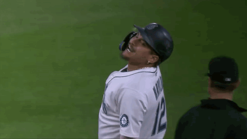 A Baseball Player Wearing A Jersey That Says Mariners On It GIF