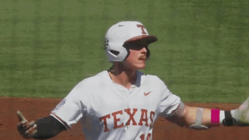 a baseball player wearing a jersey that says " texas " on it