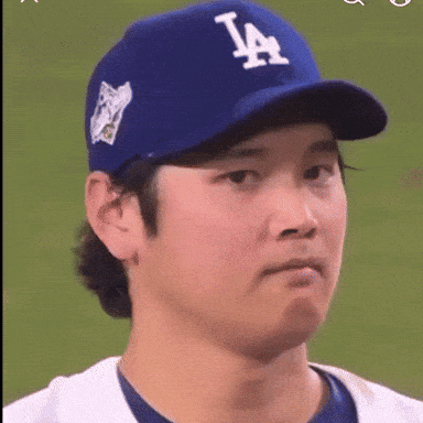 A Baseball Player Wearing A La Hat Makes A Face GIF