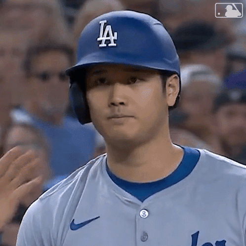 A Baseball Player Wearing A La Helmet And Jersey GIF