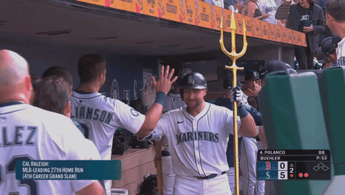 A Baseball Player Wearing A Mariners Jersey High Fives His Teammates GIF