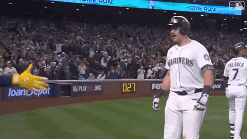 A Baseball Player Wearing A Mariners Jersey Is Standing On The Field GIF