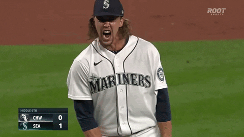A Baseball Player Wearing A Mariners Jersey Stands On The Field GIF