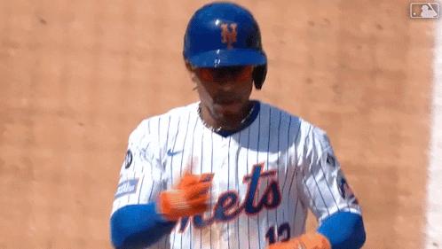 a baseball player wearing a mets jersey and helmet