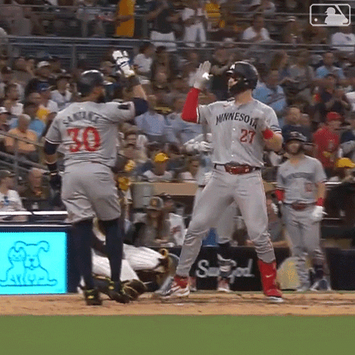 A Baseball Player Wearing A Minnesota Jersey Stands On The Field GIF