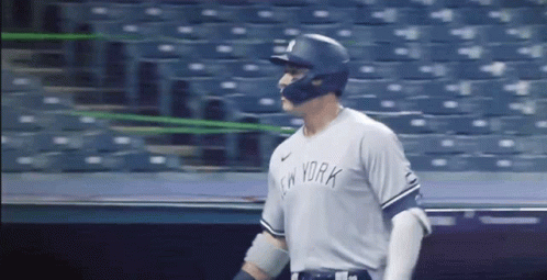 A Baseball Player Wearing A New York Jersey And Helmet GIF