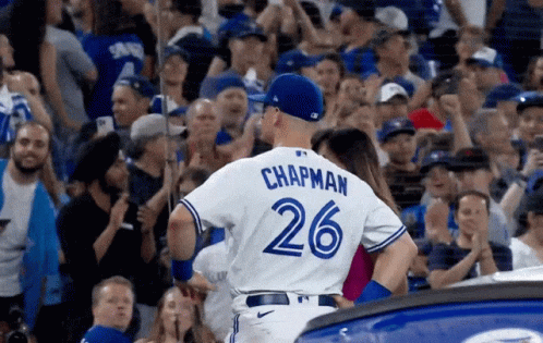 A Baseball Player Wearing A Number 26 Jersey Stands In Front Of A Crowd GIF
