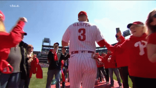 A Baseball Player Wearing A Number 3 Jersey Is Surrounded By Fans GIF