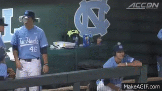 A Baseball Player Wearing A Number 46 Jersey Stands In The Dugout GIF