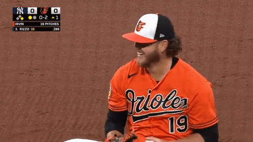 A Baseball Player Wearing A Orioles Jersey Is Holding A Ball GIF