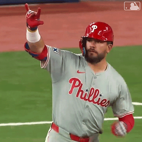 A Baseball Player Wearing A Phillies Jersey Is Pointing Up GIF