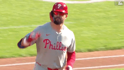 A Baseball Player Wearing A Phillies Jersey Is Running On The Field GIF
