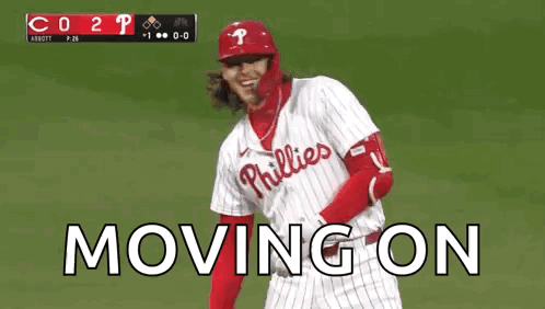 A Baseball Player Wearing A Phillies Uniform Is Standing On A Field . GIF