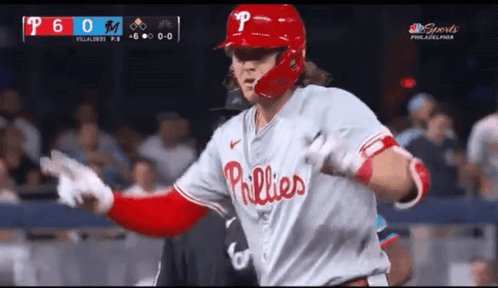 A Baseball Player Wearing A Phillies Uniform Runs Towards The Dugout GIF
