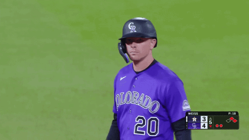 a baseball player wearing a purple uniform with colorado 20 on it