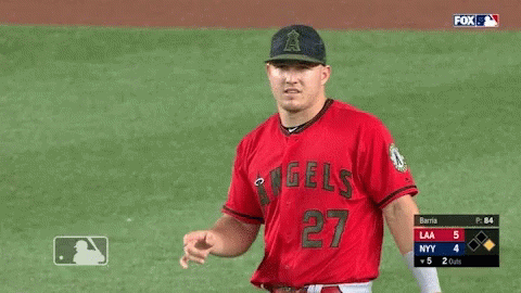 A Baseball Player Wearing A Red Angels Jersey Is Pointing GIF