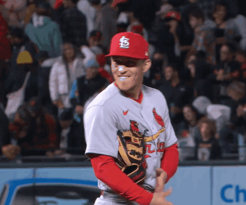 A Baseball Player Wearing A Red Cardinals Hat And Glove GIF