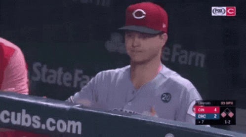 a baseball player wearing a red cubs hat