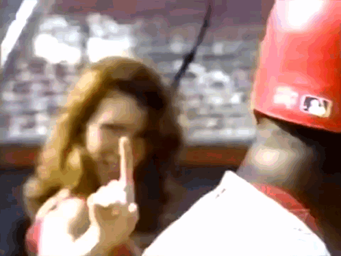 A Baseball Player Wearing A Red Hat With A Mlb Logo GIF