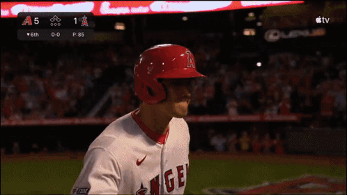 a baseball player wearing a red helmet with the word angels on it