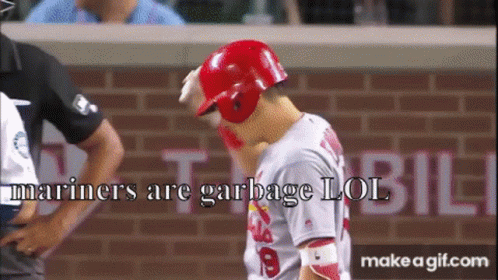 A Baseball Player Wearing A Red Helmet With The Words Mariners Are Garbage Lol GIF