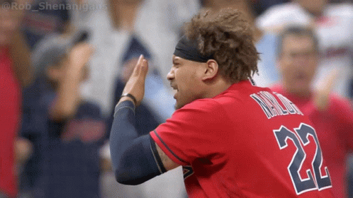 A Baseball Player Wearing A Red Jersey With The Number 22 On The Back GIF