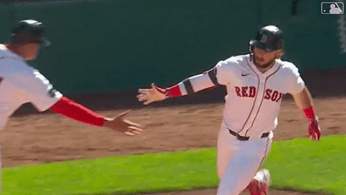 A Baseball Player Wearing A Red Sox Jersey Is Running On The Field . GIF