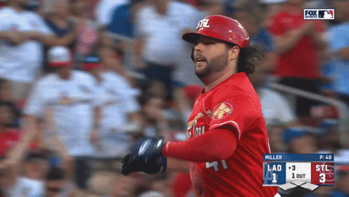 A Baseball Player Wearing A Red Uniform With The Letters Stl On It GIF